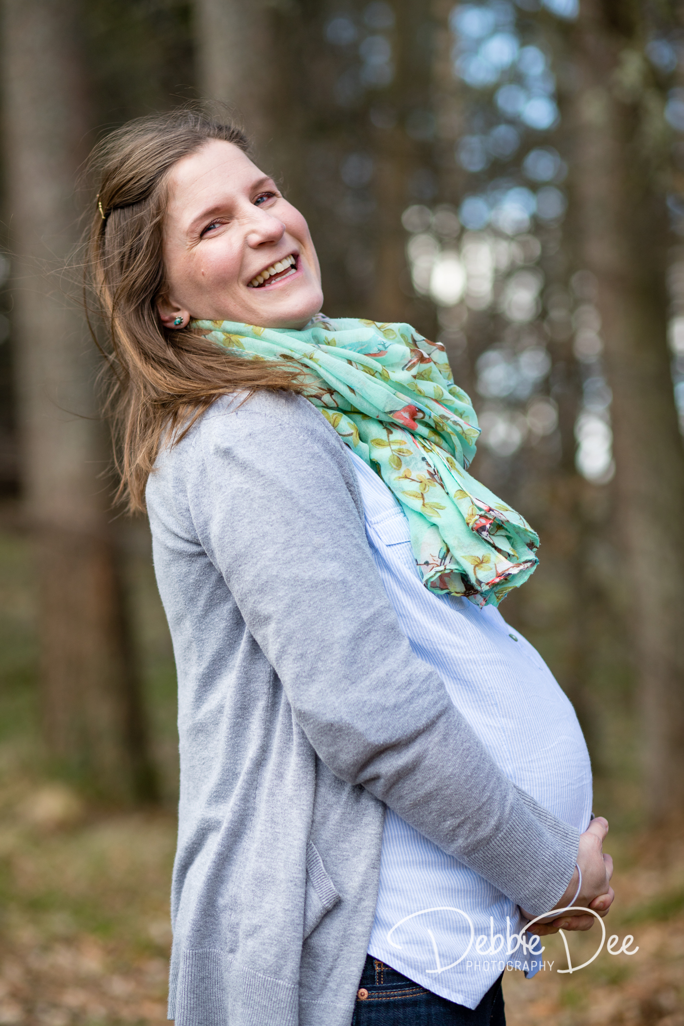 Aberdeenshire Family Maternity Photography Session pregnant mum laughing and holding bump